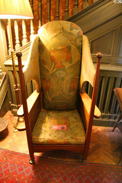 Oak porter wing-back chair (early 20thC) with unknown upholstery at Wightwick Manor. Wolverhampton, England.