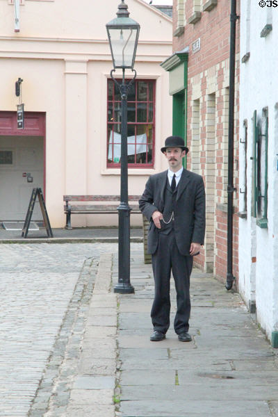 Interpreter in dress of late 1800s era at Ulster Folk Park. Belfast, Northern Ireland.