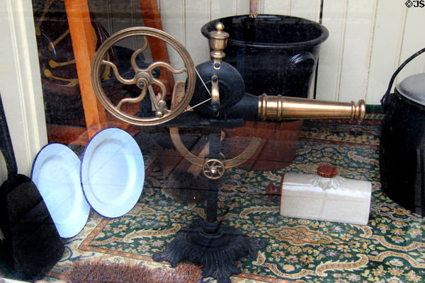Antique rotary hand-cranked bellows in hardware store window at Ulster Folk Park. Belfast, Northern Ireland.