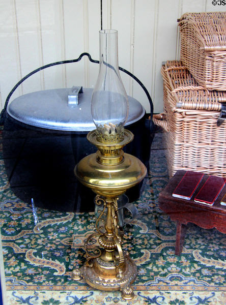 Antique brass oil lamp in hardware store window at Ulster Folk Park. Belfast, Northern Ireland.