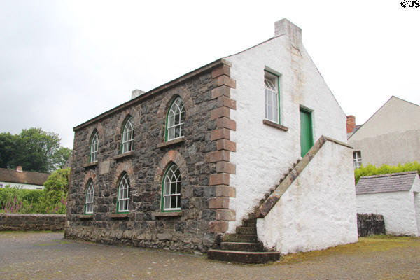 Gothic revival National School with stone front (1837 & c1900) from Ballycastle on Chapel Lane at Ulster Folk Park. Belfast, Northern Ireland.