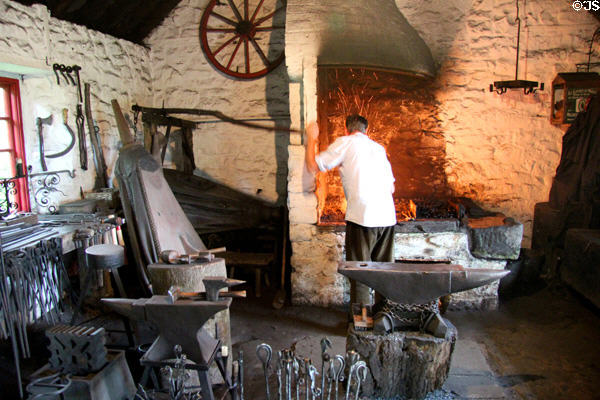Blacksmith working in Lisrage Forge at Ulster Folk Park. Belfast, Northern Ireland.
