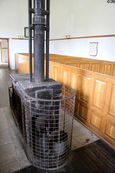 Stove & box pews (1790s) in Church of Ireland from Carnacally at Ulster Folk Park. Belfast, Northern Ireland.