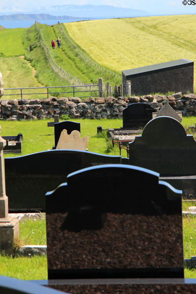 Gravestones & hiking trail at Ballintoy Parish Church. Ballintoy, Northern Ireland.