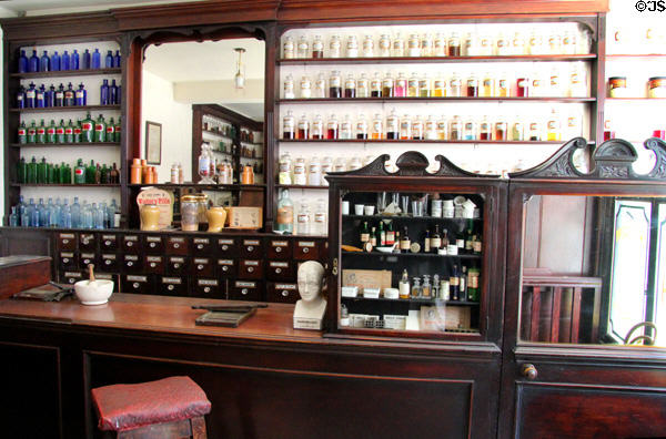 Pharmacy bottles & cabinets in J Hill Chemist shop at Ulster American Folk Park. Omagh, Northern Ireland.