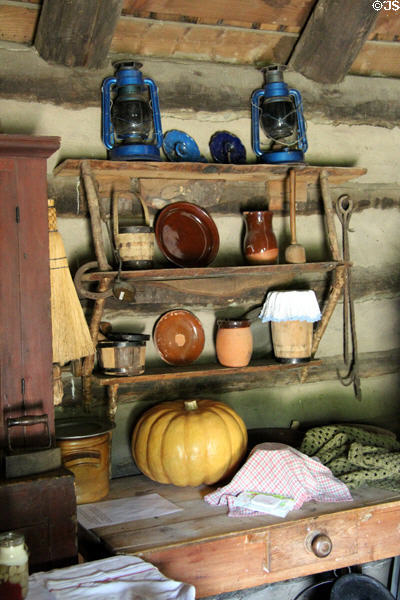 Rustic shelf with earthenware plates in Log Cabin at Ulster American Folk Park. Omagh, Northern Ireland.
