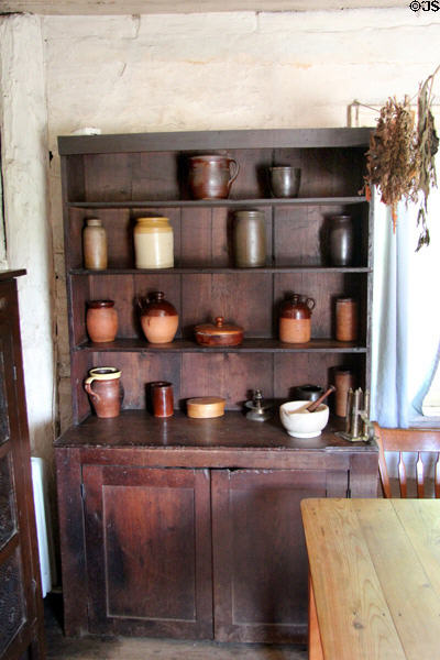 Sideboard with crockery in Pennsylvania Log Farmhouse at Ulster American Folk Park. Omagh, Northern Ireland.