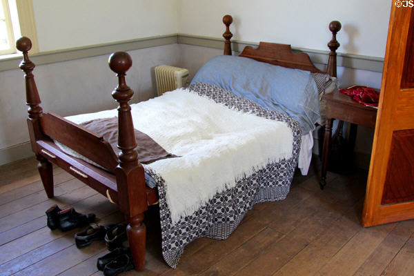 Four-poster rope bed in brick house at Ulster American Folk Park. Omagh, Northern Ireland.