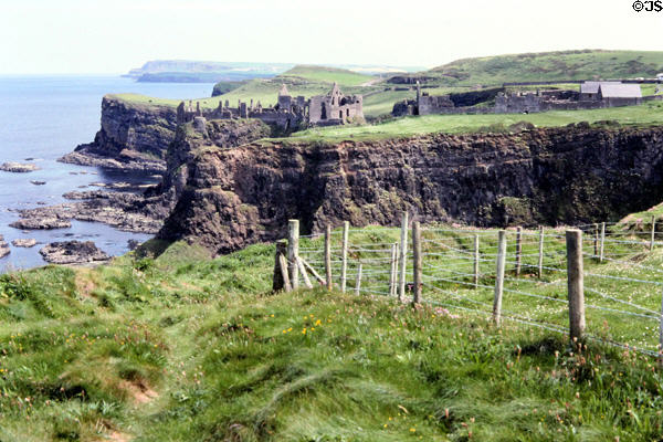 Dunluce Castle perched on Causeway Coast cliffs. Northern Ireland.