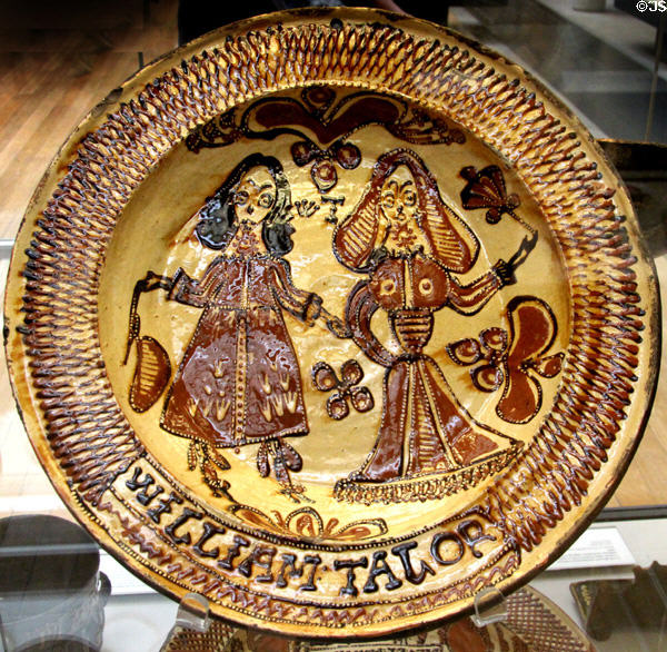 Earthenware slip glazed dish with cavalier & lady (1675) by William Talor of Burslem, Staffordshire at British Museum. London, United Kingdom.