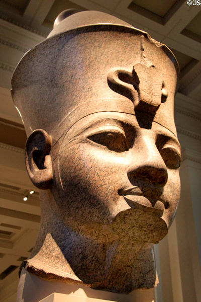 Red granite colossal head of a king (18th Dynasty - 1390? BCE) from Thebes at British Museum. London, United Kingdom.