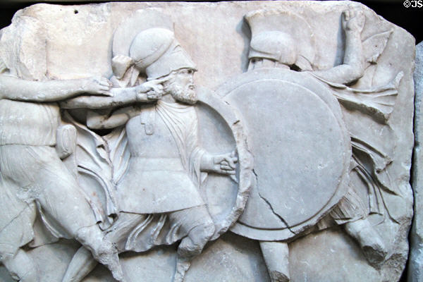 Frieze of soldiers of two sides in different helmets fighting hand to hand on Nereid Monument (390 BCE-380 BCE) at British Museum. London, United Kingdom.