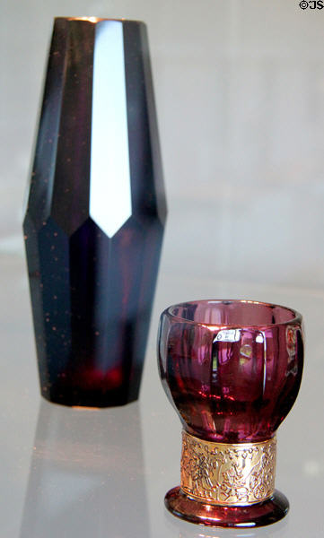 Amethyst 12-sided glass vase (c1914-5) by Josef Hoffmann & gilded ruby glass goblet form vase (c1920) by Carl Goldberg of Bohemia at Mobile Museum of Art. Mobile, AL.