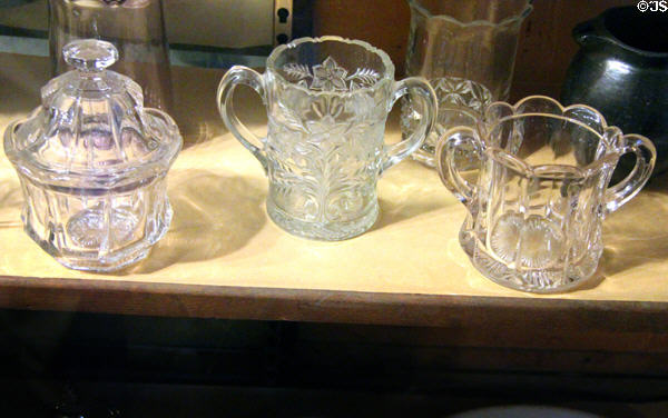 Pressed glass sugar bowl & two-handled cups at Bird Cage Theatre. Tombstone, AZ.