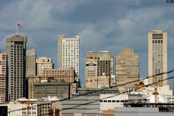 Highrises which surround Union Square marked by star-topped Starlight Room seen from residential hills south of city. San Francisco, CA.