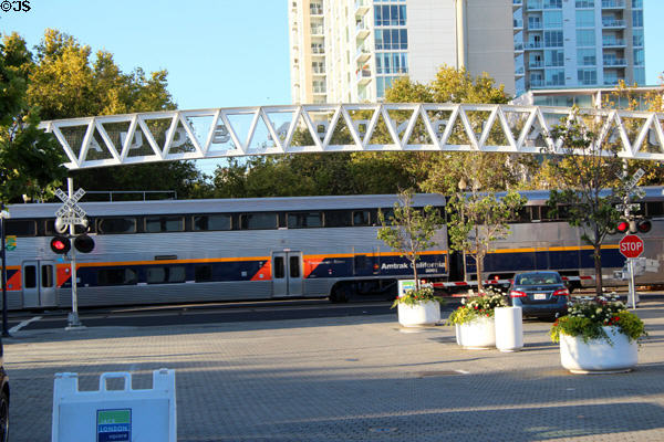 Amtrak train passes at Jack London Square. Oakland, CA.