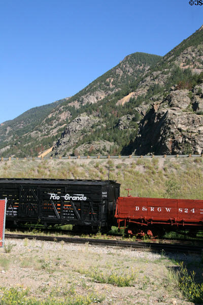 Rolling stock of Georgetown Loop Railroad against mountain pierced with abandoned silver mines. Silver Plume, CO.