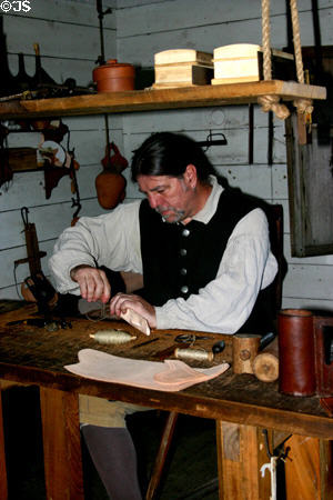 Leather craftsman at Colonial Spanish Quarter Museum. St Augustine, FL.