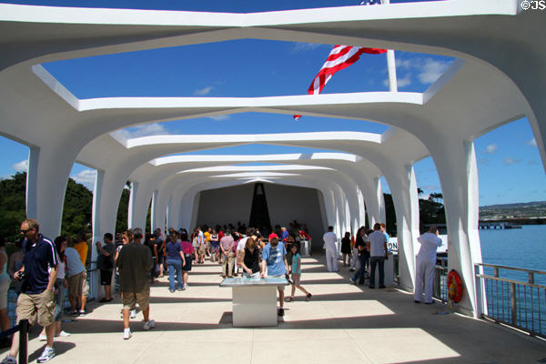 Visitors contemplate memory of men lost on sinking of USS Arizona at Pearl Harbor memorial. Honolulu, HI.