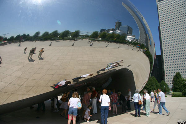 Cloud Gate provides a 12-foot-high arch through the 66-feet long by 33-feet high reflective sculpture in Millennium Park. Chicago, IL.