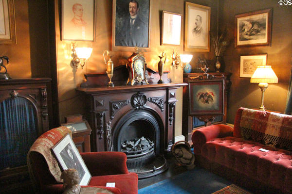 Parlor fireplace with portraits of Charles Gibson at Gibson House Museum. Boston, MA.