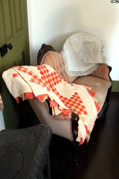 Sofa with quilt in Jackson County Marshall's House. Independence, MO.