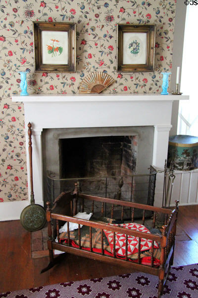 Cradle in front of master bedroom fireplace at John Wornall House Museum. Kansas City, MO.