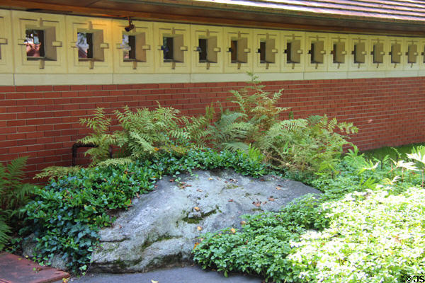 Concrete window frames on wall integrated with boulder at Zimmerman House. Manchester, NH.