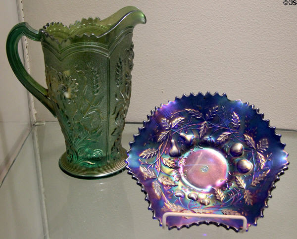 Carnival Glass green pitcher by Imperial Glass Co. & blue bowl fruits & flowers by Northwood Glass Co. at Museum of American Glass. Milville, NJ.