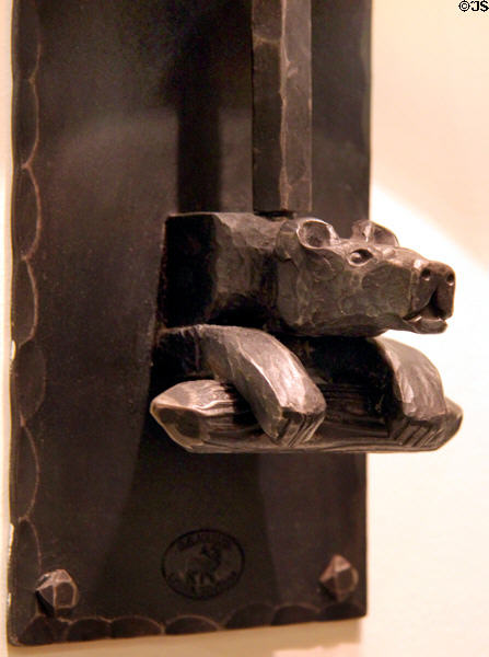 Detail of bear on metalwork wall lamp with western theme at Rockwell Museum of Art. Corning, NY.