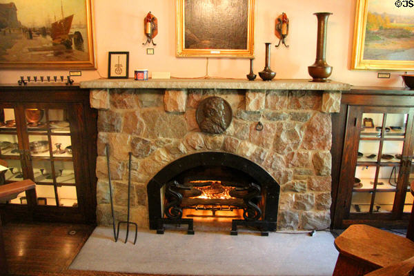 Living room fireplace with flanking enclosed bookcases at Elbert Hubbard Roycroft Museum. East Aurora, NY.