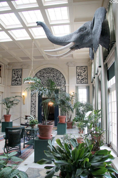 Conservatory with decorative entrance to dining room at far end at Eastman House. Rochester, NY.