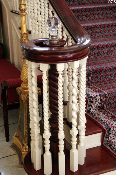 Front staircase newel post encircled by finely & variously carved rails at Eastman House. Rochester, NY.