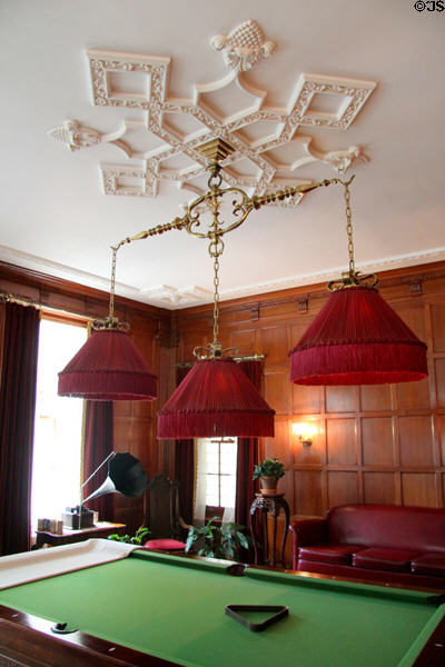 Billiard table with lamps hung from plasterwork ceiling medallion at Eastman House. Rochester, NY.