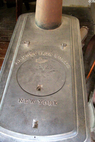Antique cast iron Pine Knot wood stove (c1868) by J.L. Mott Iron Works of New York in Layton General Store at Old Bethpage Village. Old Bethpage, NY.