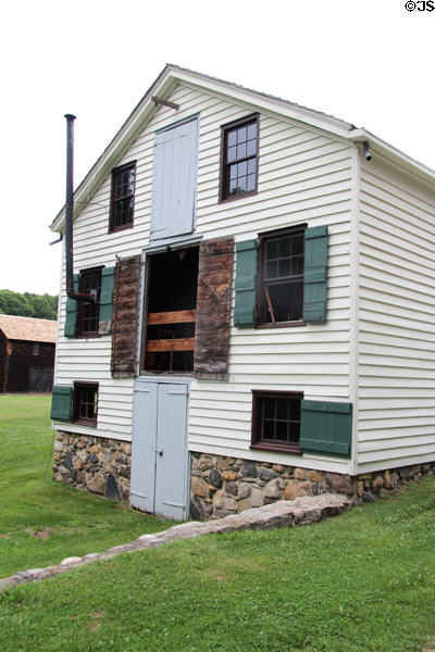 Luyster Store (early 1800s) three-story rear facade with ground level storage where wagons unloaded at Old Bethpage Village. Old Bethpage, NY.
