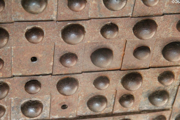 Secret rivet plate slid to hide keyhole on safe in Luyster Store at Old Bethpage Village. Old Bethpage, NY.