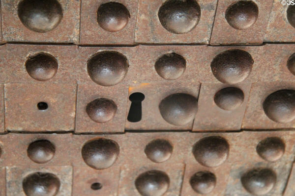 Secret rivet plate slid to reveal keyhole on safe in Luyster Store at Old Bethpage Village. Old Bethpage, NY.