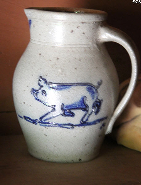 Ceramic pitcher with painted pig in Ritch Hat Shop at Old Bethpage Village. Old Bethpage, NY.