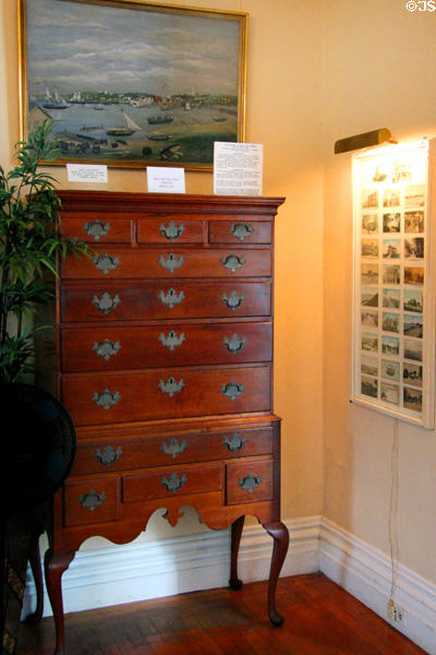 Chest on chest (1796) made of cherry wood by Nathaniel Dominy of East Hampton & painting (1860) of early Sag Harbor at Sag Harbor Whaling Museum. Sag Harbor, NY.
