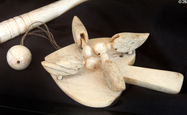 Carved ivory pecking birds paddle toy at Sag Harbor Whaling Museum. Sag Harbor, NY.