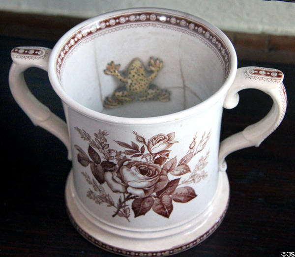 Two handled cup with frog sculpture inside at Home Sweet Home Museum. East Hampton, NY.