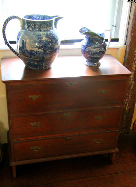 Antique pitchers with blue printed design on antique chest of drawers at Home Sweet Home Museum. East Hampton, NY.