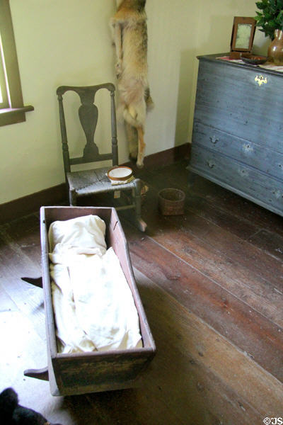 Colonial era cradle & wicker seat chair at Thomas Halsey Homestead. South Hampton, NY.