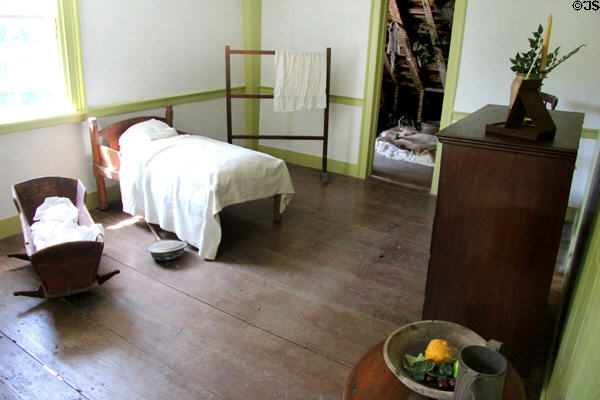 Upstairs bedroom with antique child's bed, cradle & bed warmer at Thomas Halsey Homestead. South Hampton, NY.