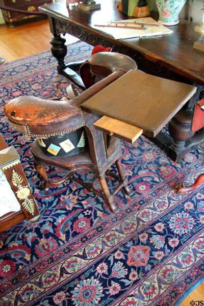 Georgian writing desk with pull-out ink tray where user straddles backward chair in Mr. Vanderbilt's bedroom at Vanderbilt Mansion. Centerport, NY.