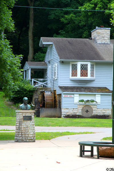 Grist mill with statue of Carillon Historical Park founder Col. Edward A. Deeds. Dayton, OH.