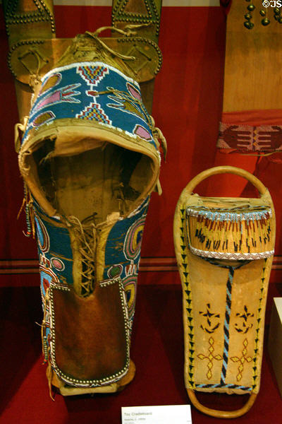 Kiowa cover on Apache cradle board (c1890) plus toy Apache cradleboard at Oklahoma History Center. Oklahoma City, OK.