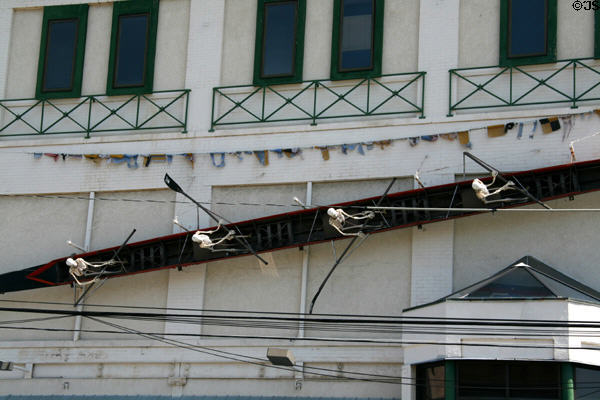 Skeleton crew skulling in rowing boat on side of building opposite Lackawanna County Courthouse. Scranton, PA.