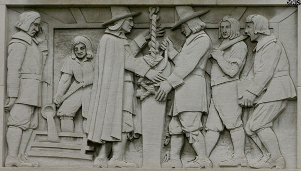 Relief of early settlers casting a canon on Bank of America Building. Providence, RI.